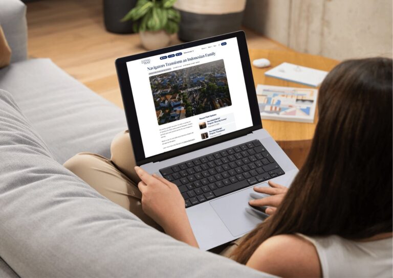 A woman reads a Leading the Way email on a laptop computer