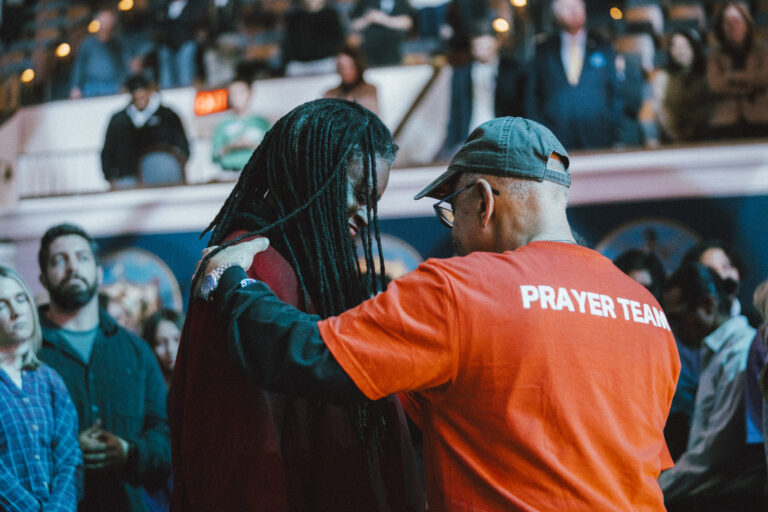 Prayer teams at AWAKE DC Prayer Rally praying for attendees in tears