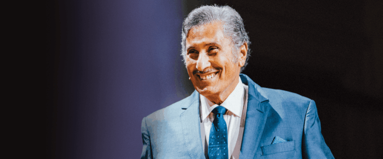 Dr. Michael A Youssef smiling on stage