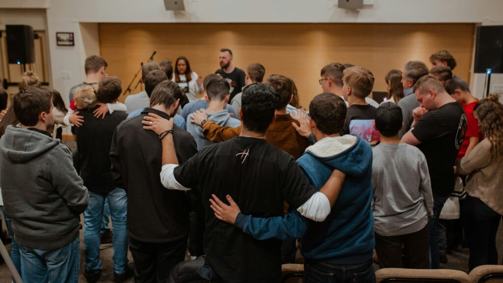 group of young men praying