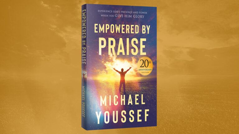Empowered By Praise book in front of gold background