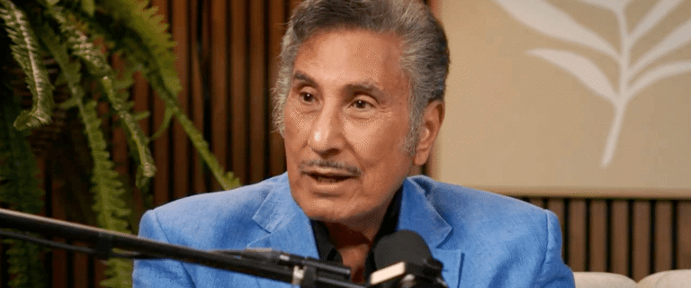 Dr. Michael A. Youssef speaks into a microphone while wearing a blue jacket.